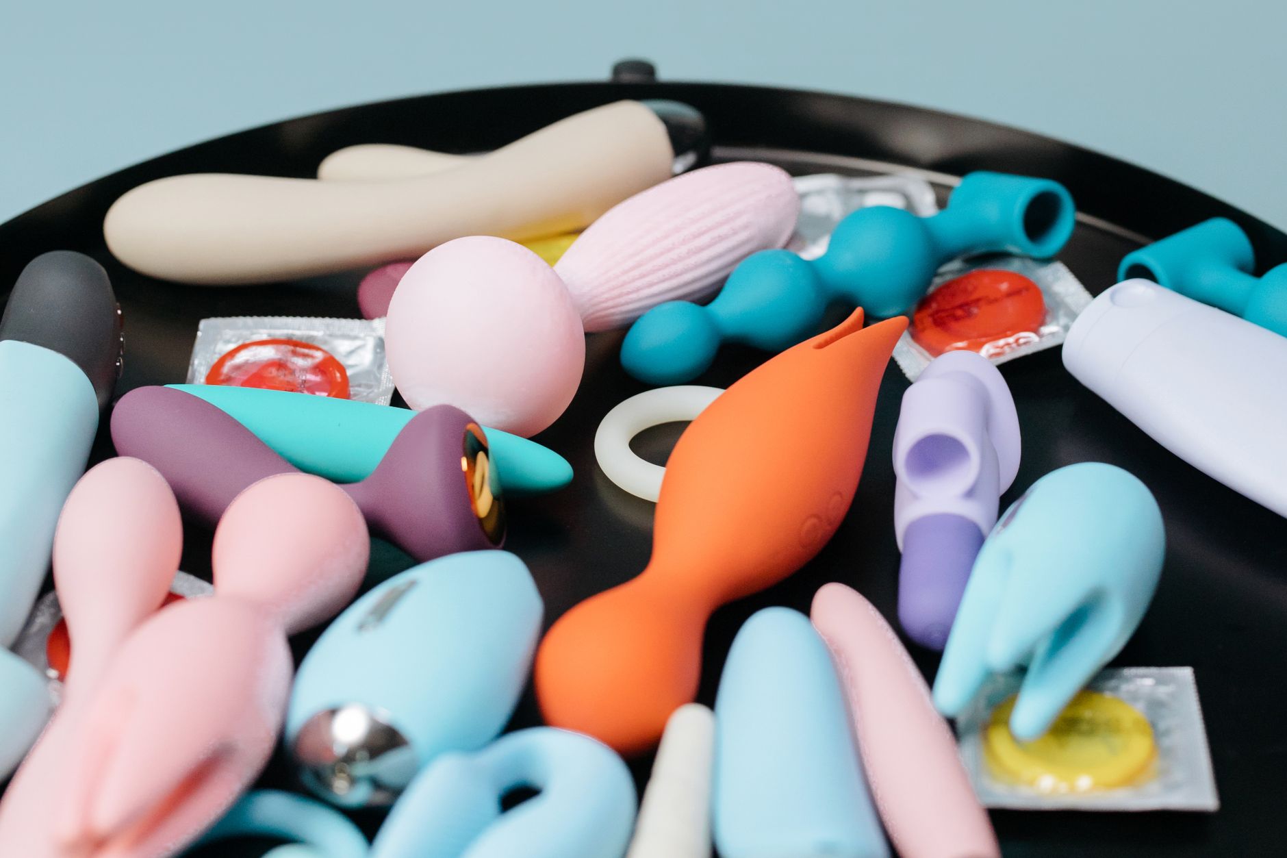 A blue silicone vibrator held in hand, representing modern intimacy and pleasure exploration